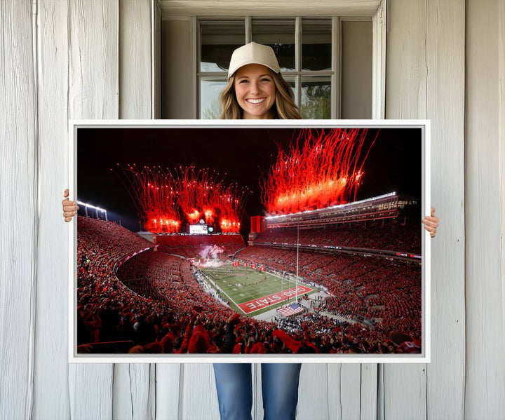 A vibrant red canvas art of a packed Ohio State Buckeyes stadium at night with fireworks.