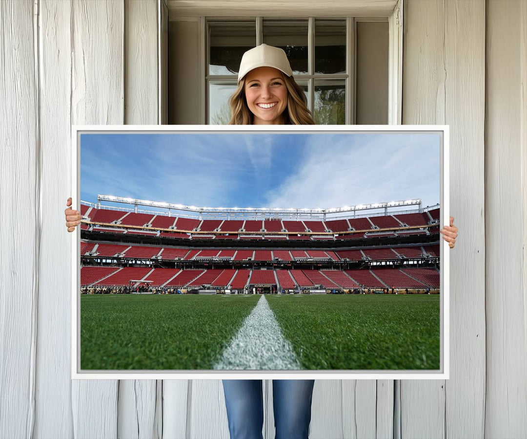 A canvas print of the University of Tulsa Golden Hurricane showcases H.A. Chapman Stadiums football field and red seats against a backdrop of a blue sky.