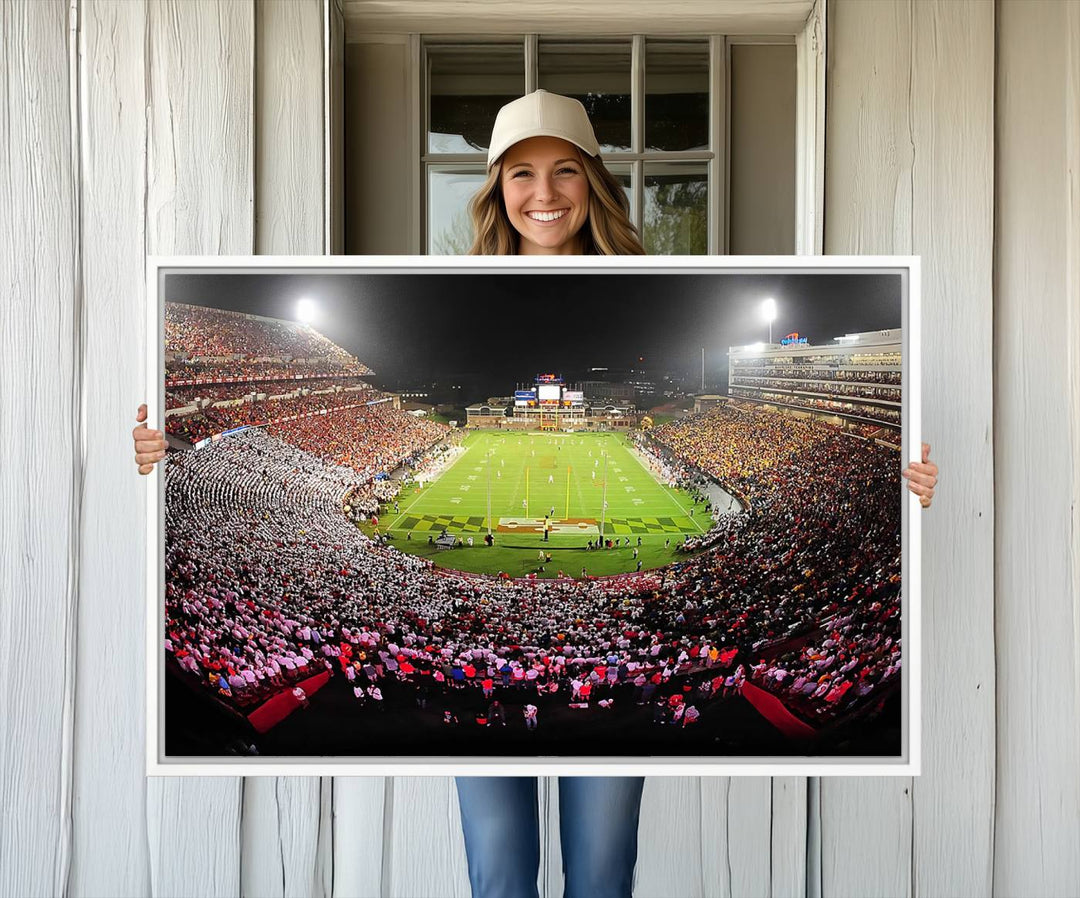 The Maryland Terrapins Football Wall Art Canvas showcases a packed SECU Stadium at night with a bright field and cheering fans.