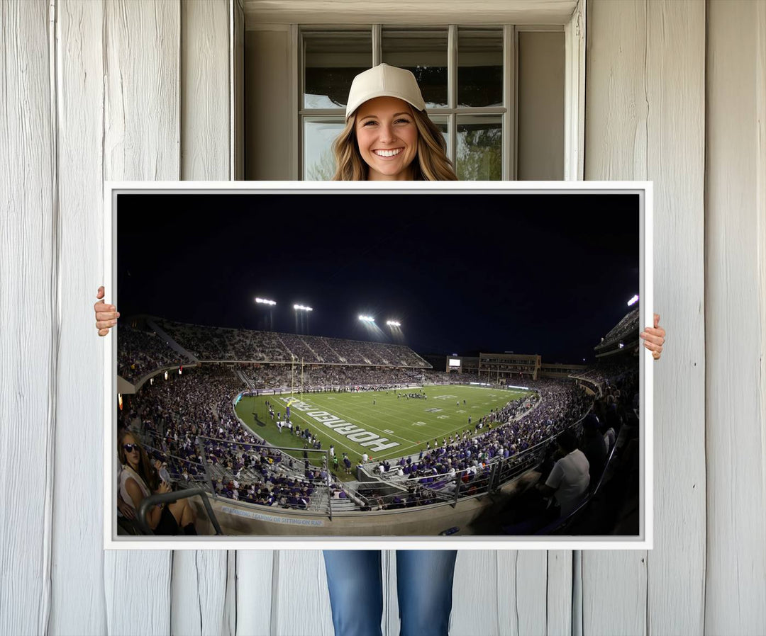 The wall art print features a night view of Amon G. Carter Stadium filled with TCU fans, showcased in the Horned Frogs Football Canvas Wall Art.