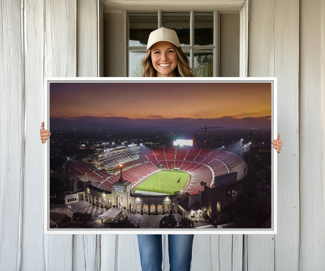 The USC Trojans Stadium canvas captures Memorial Coliseum at twilight, showcasing red seats and a green field beneath an orange sky.