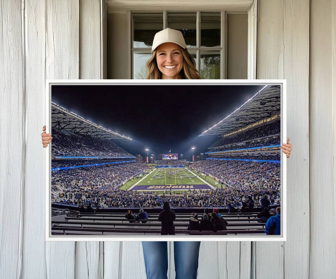 A canvas print titled The University of Washington Huskies Football depicts a packed Husky Stadium at night, as seen from the stands.