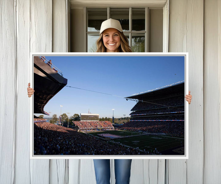 The University of Washington Huskies wall art print depicts Husky Stadium coming alive with fans as flags flutter.