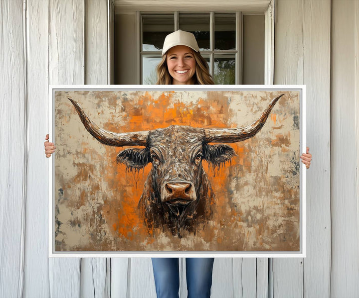 Abstract Cow Longhorn Bull Wall Art presents a detailed face centered on a textured orange and beige background.