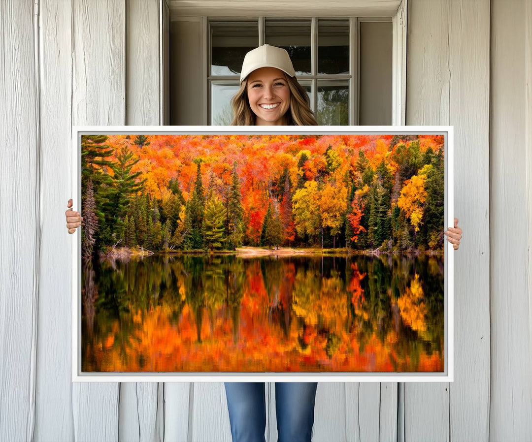 Autumn Forest Reflection Wall Art: a vibrant triptych canvas featuring fall foliage with red, orange, and yellow leaves over a calm lake.