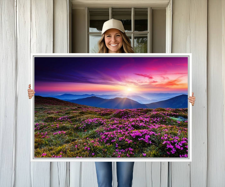 A 3-panel landscape photography canvas of a sunset over mountain meadows with purple wildflowers decorates the wall.