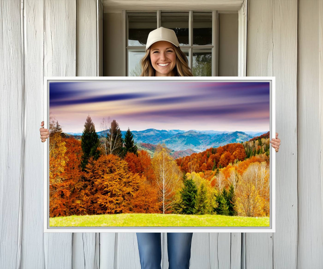 The wall art in the kitchen dining area is a large Autumn Forest Mountain Canvas Print that captures a vivid scenic landscape.