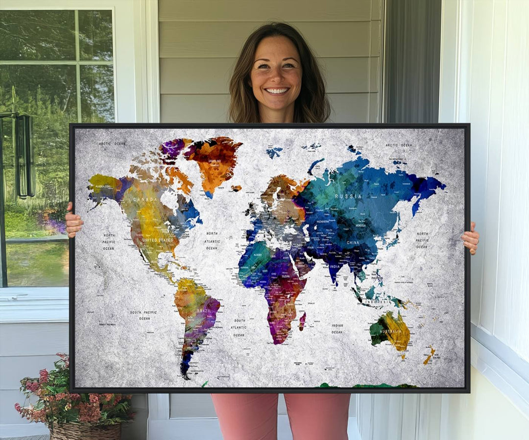 The World Map Art Canvas Print, featuring country names on a grunge-stained gray background, is perfect for stylish home decor.