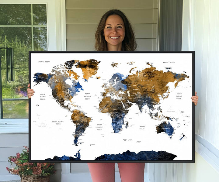 The Watercolor World Map Canvas showcases a grunge-stained background in gold, gray, and blue hues.