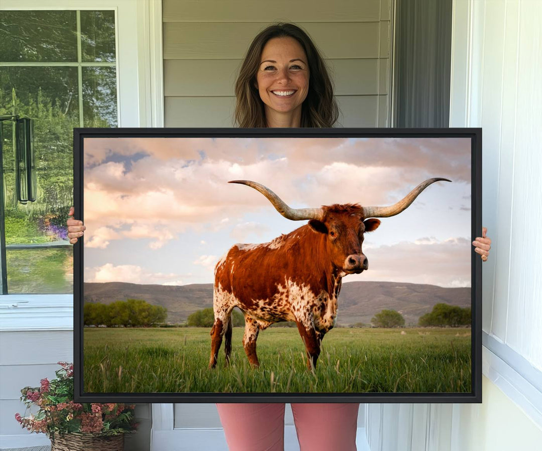 The Texas Cow Canvas Wall Art print captures a longhorn cow at sunset and is ready to hang.