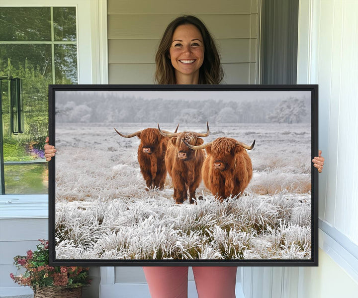 The Highland Cows in Snow canvas showcases three cattle in a frosty field.