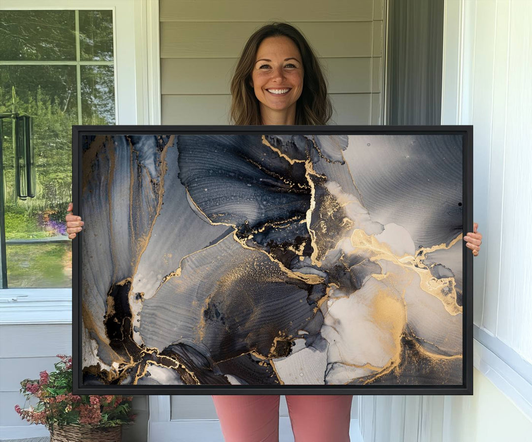 A Modern Marble Fluid Effect Abstract Wall Art with black, white, and gold swirls hangs in a modern kitchen.