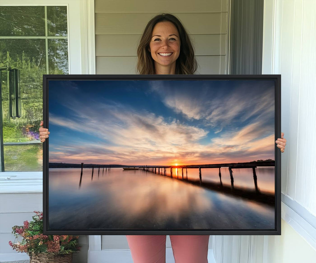 The Sunset Pier Canvas features a serene coastal landscape with vibrant hues under cloudy skies, ideal for modern decor.