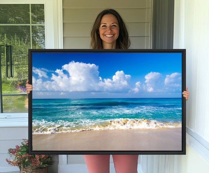 The Tropical Beach 3-Panel Canvas Wall Art features ocean waves gently lapping on a beach under blue skies, making it an ideal choice for coastal decor.