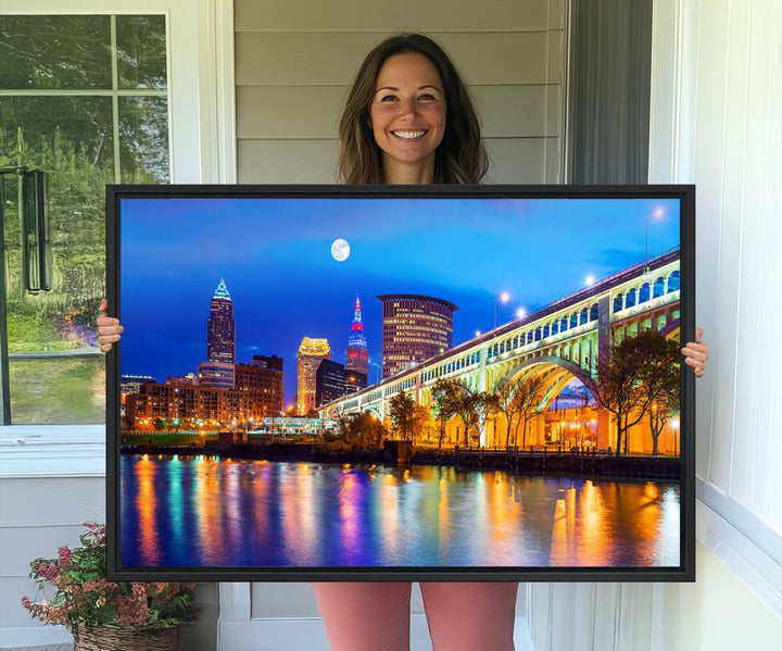 A Cleveland Night Skyline Wall Art on museum-quality canvas showcases a bridge and illuminated buildings.