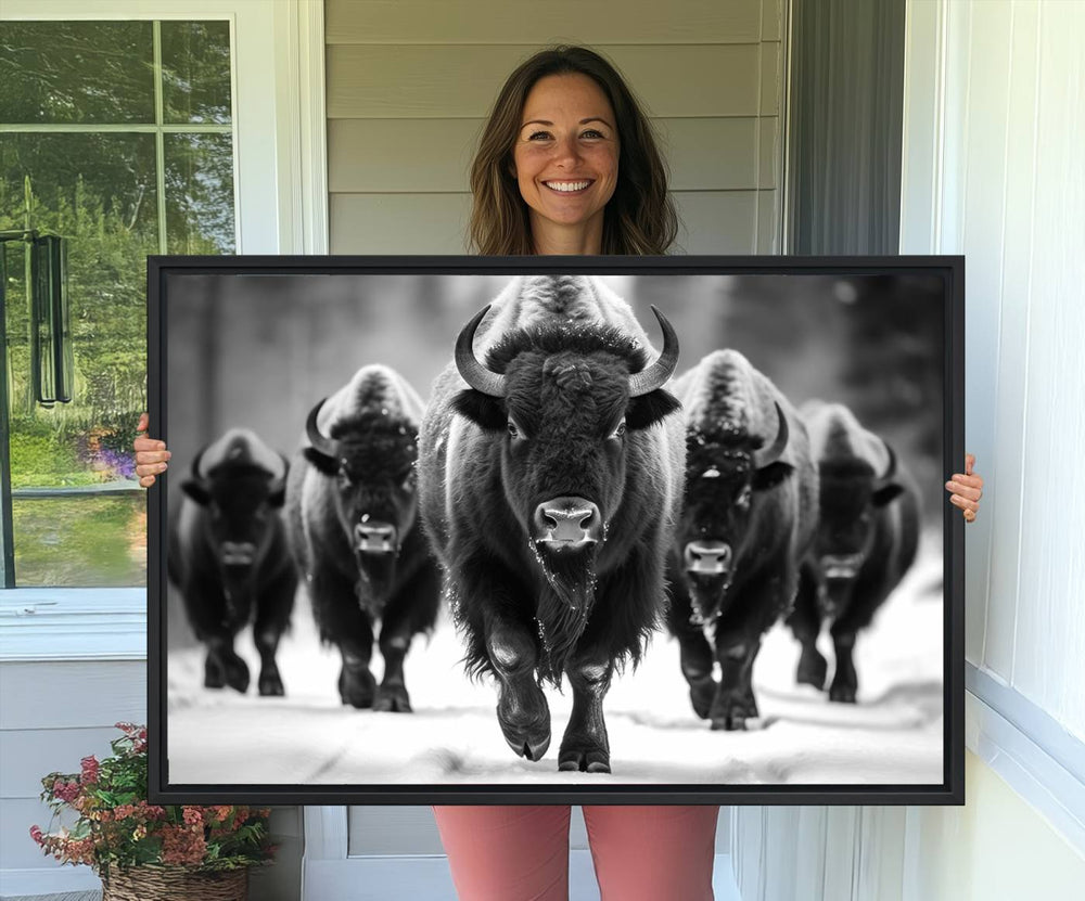 A black and white American Bison herd canvas print adorns the wall.