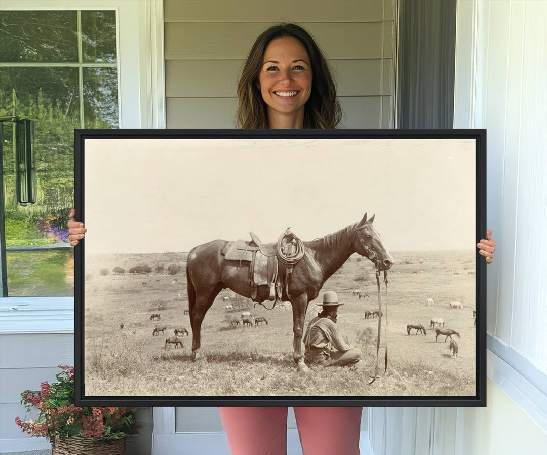 Cowboy Wall Art - Vintage Western Horse Canvas Print features a cowboy kneeling by his horse in a field.