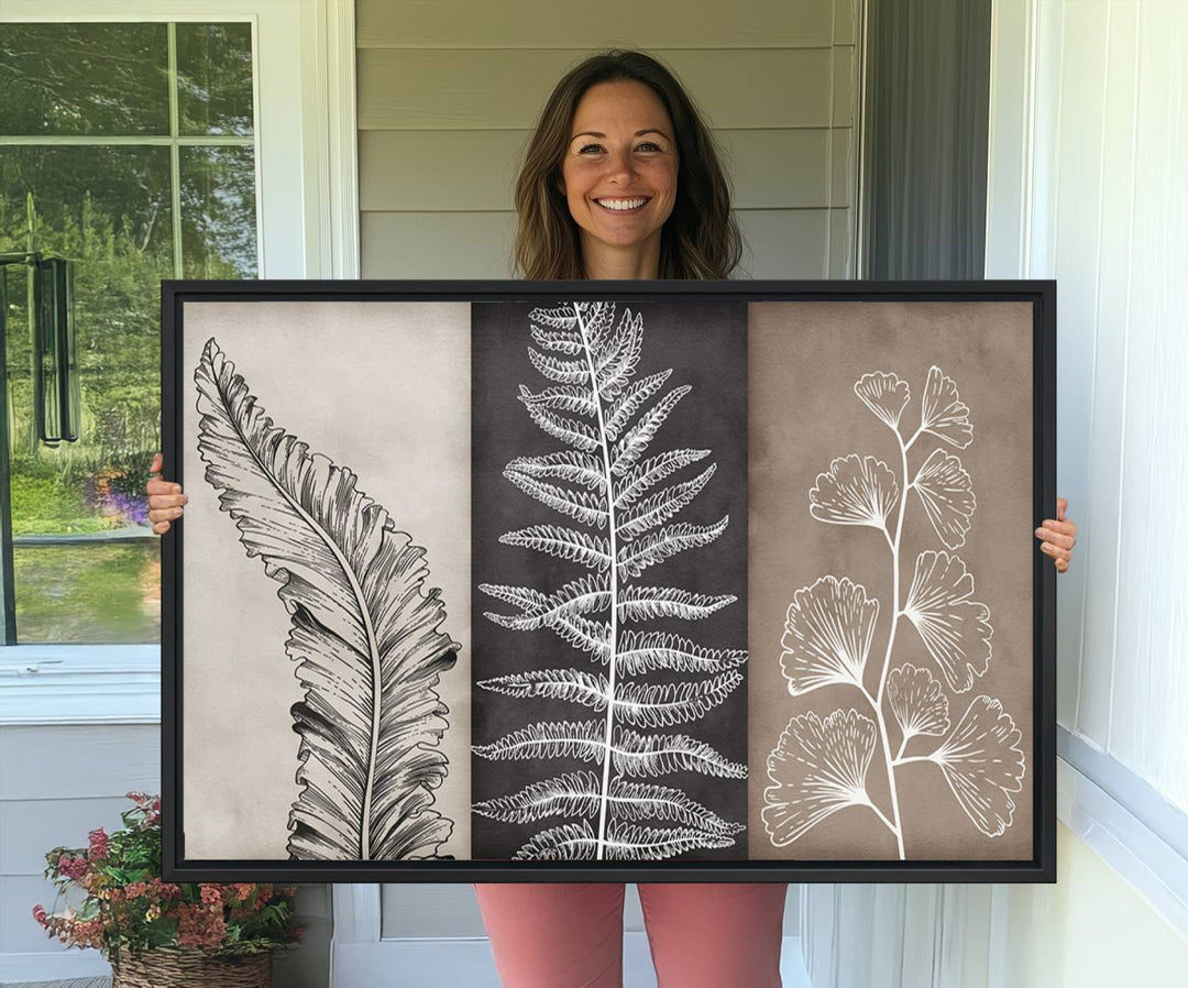 Three framed botanical wall art pieces are displayed in a bright room.