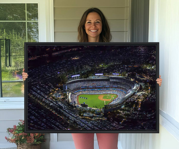 A large Los Angeles Dodgers print of Dodger Stadium at night is displayed near a window.