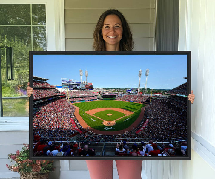 The Cincinnati Reds Baseball Team print of Great American Ball Park Stadium adorns the wall.