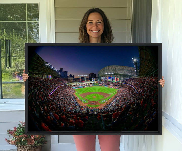 A canvas print of Houston Minute Maid Park at dusk is mounted on the wall.