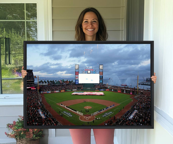 This framed 3-panel canvas MLB wall art features a giant flag and fans under a cloudy sky at Oracle Park.