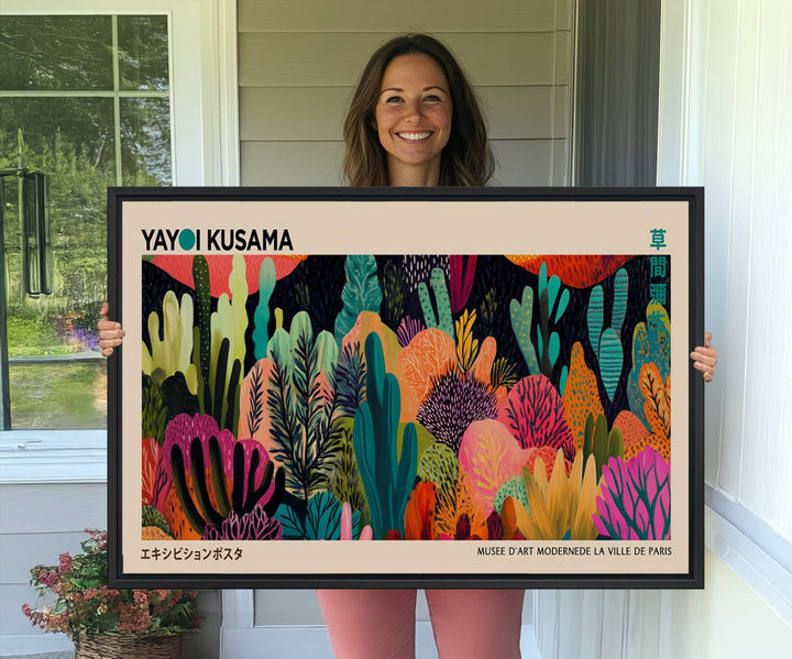 The vibrant canvas print of wall art features abstract plants, with the elegant text "Yayoi Kusama Wall Art Canvas Print" displayed on the colorful frame.