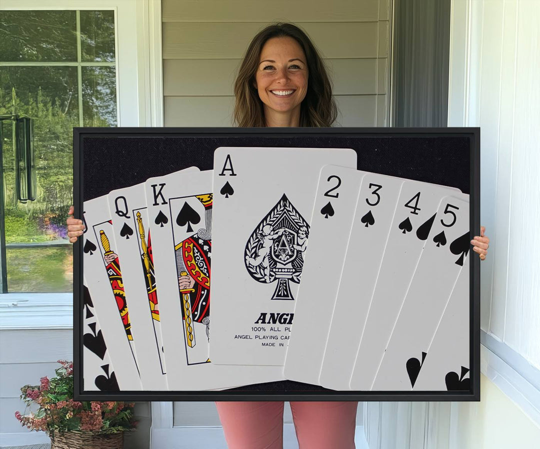 The Poker Wall Art - Playing Cards Canvas Wall Art Print features an Ace of Spades and Royal Flush design. This piece adds a classic charm to any space with its subtle emphasis on the Ace of Spades, making it perfect for game room decor.