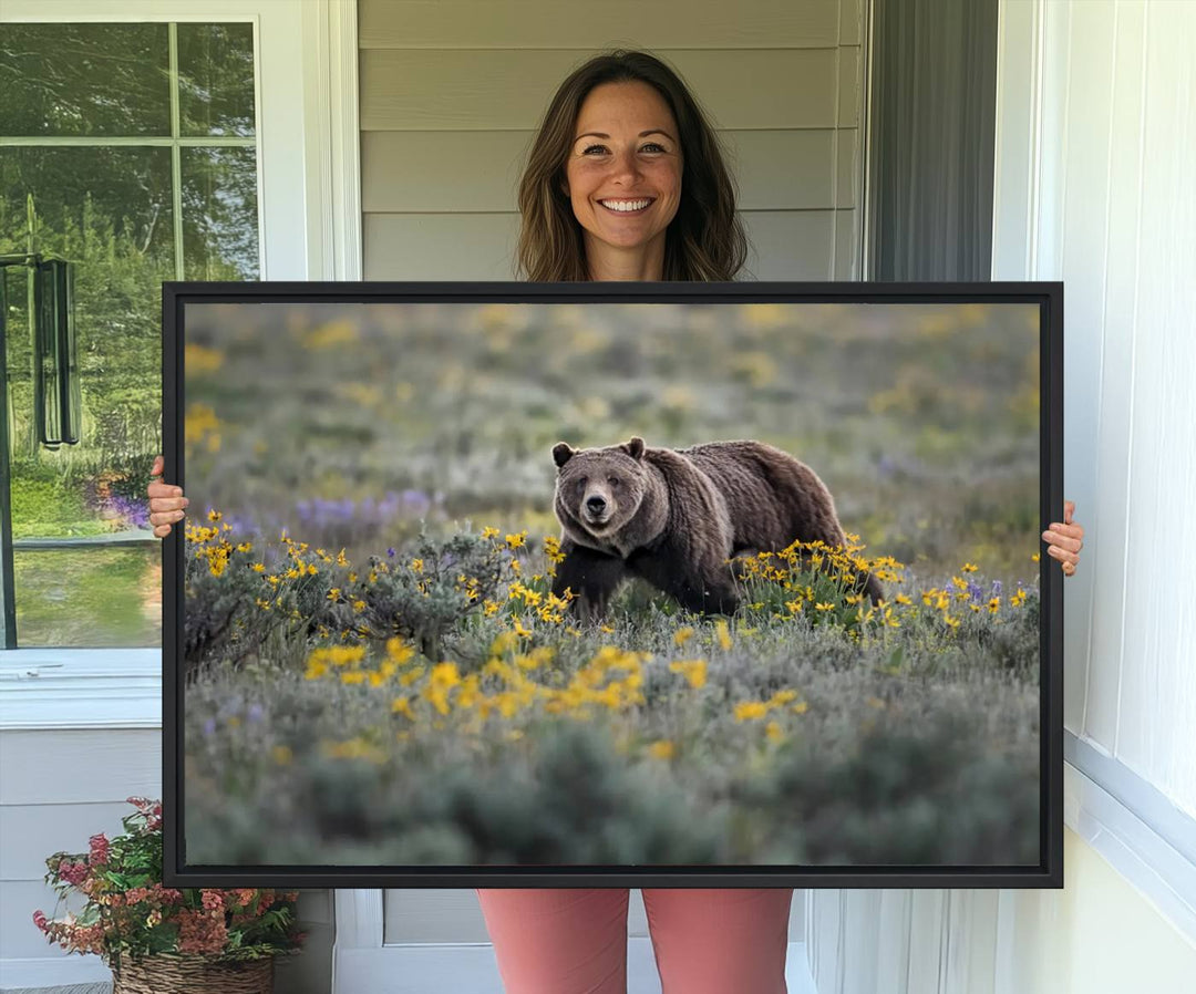 The "Grizzly 399 in Wild Flowers Wall Art Canvas Print" features a grizzly bear strolling through a field of yellow and purple flowers, beautifully showcased as a triptych. This handcrafted piece, proudly made in the USA, adds charm and sophistication to your space.