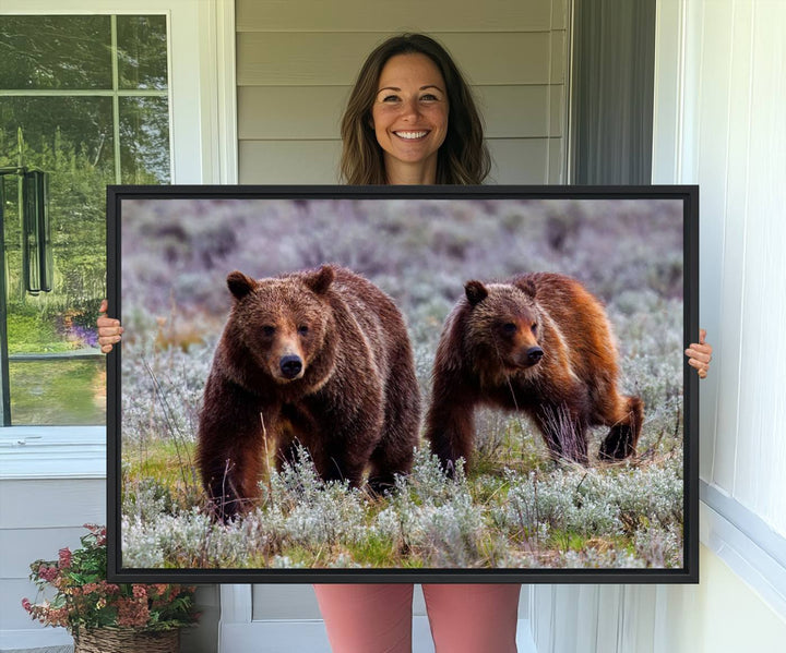 The "Queen of the Tetons" is a stunning canvas art print featuring Grizzly 399 and two bears strolling through a grassy field. Its gallery-quality finish beautifully captures the essence of nature, making it perfect for rustic home decor.