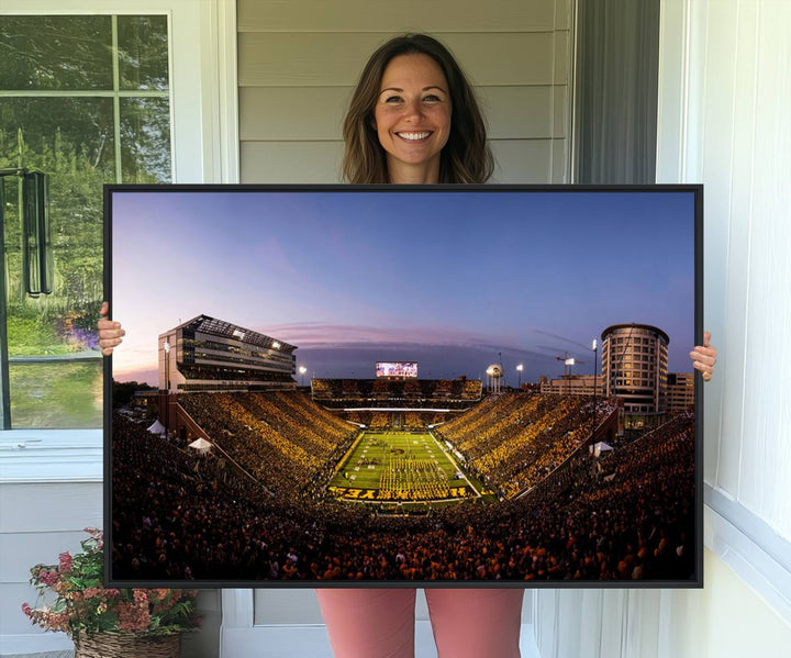 The Iowa Hawkeyes Kinnick Stadium Wall Art Canvas Print captures a sunset scene, making it perfect for display on a wall.