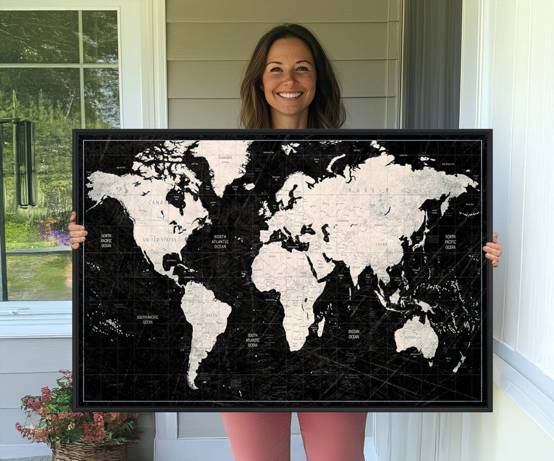 The Black & White World Map Canvas Wall Art, a giclee print, elegantly decorates the wall.