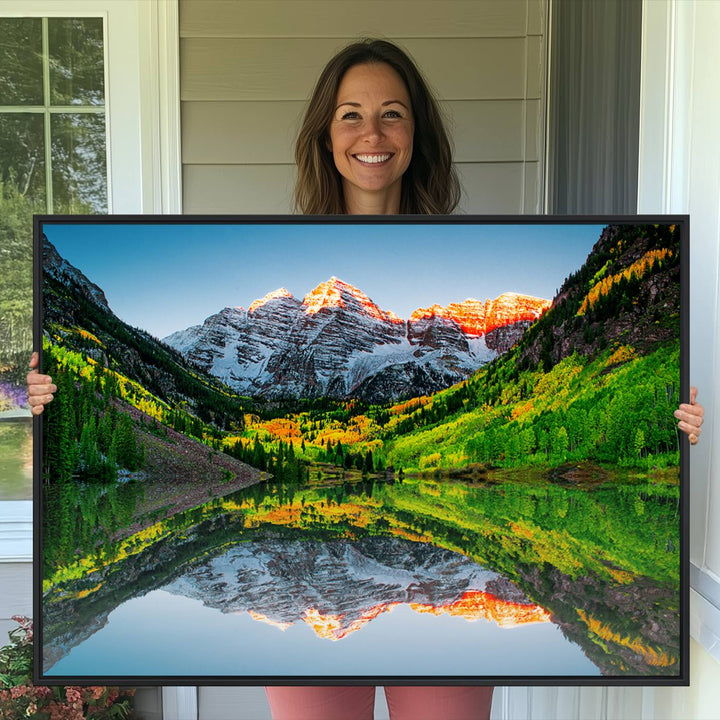 The Sunrise Maroon Bells Lake Wall Art Print beautifully captures North Maroon Peak mirrored in the tranquil lake, framed by lush greenery.