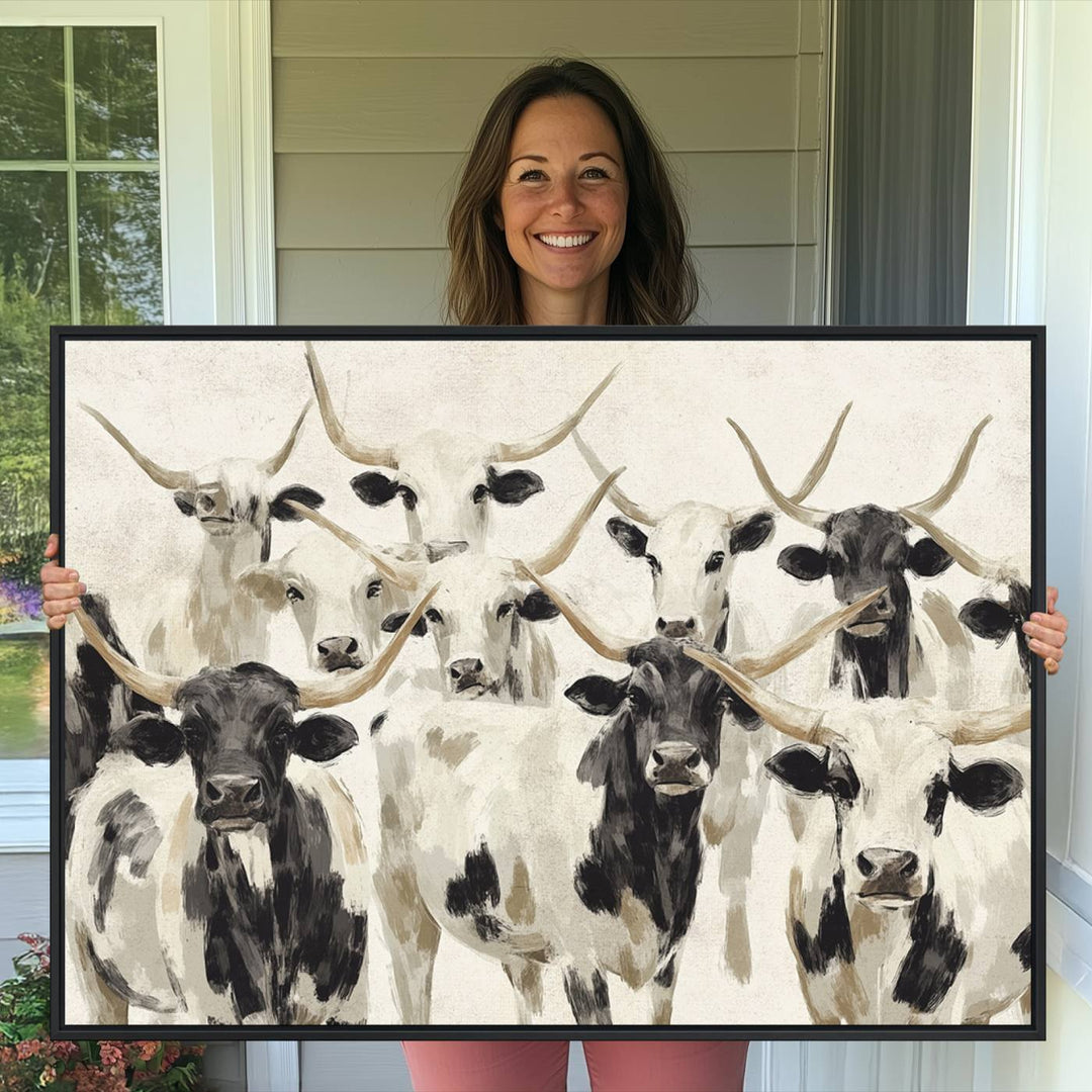 Canvas print titled Longhorn Texas Cow Drawing, depicting longhorn cattle with black and white markings, made in the USA, displayed on the wall.