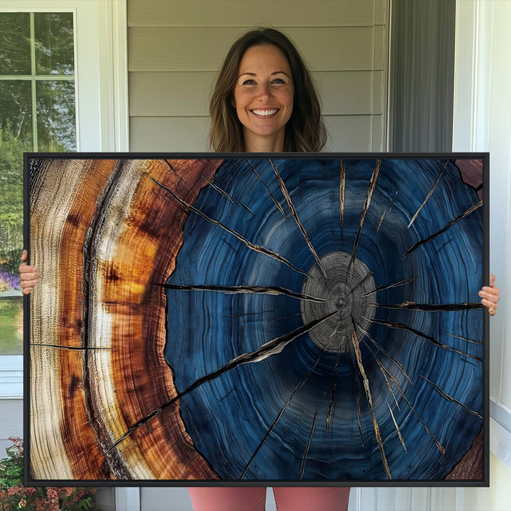 The Abstract Tree Rings Canvas Print features blue, brown, and orange rings that highlight wood grain and natures beauty.