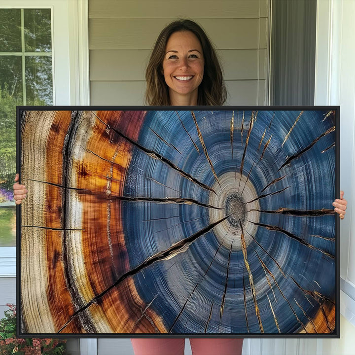 Close-up of blue, brown, and orange wood grain rings on the Abstract Tree Rings Canvas Wall Art Print.