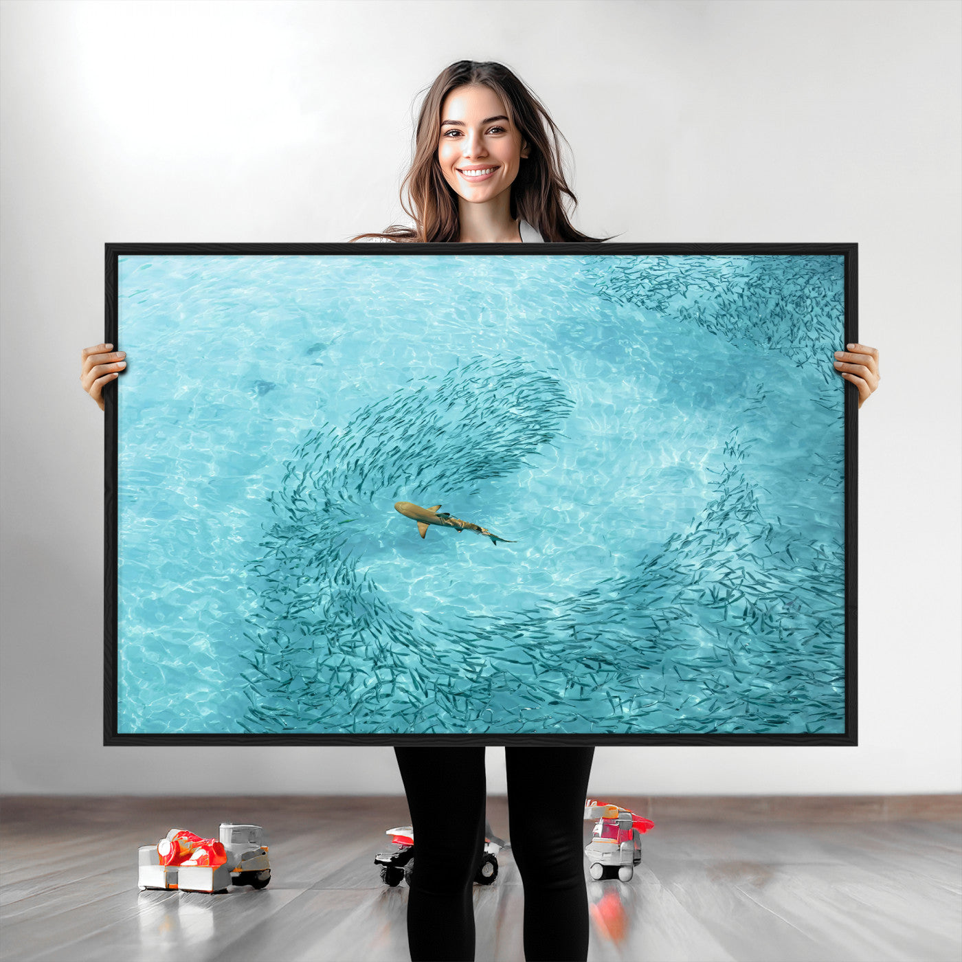 Aerial view of a shark swimming through a swirl of fish in clear turquoise waters, perfect for calm coastal or beach house decor.
