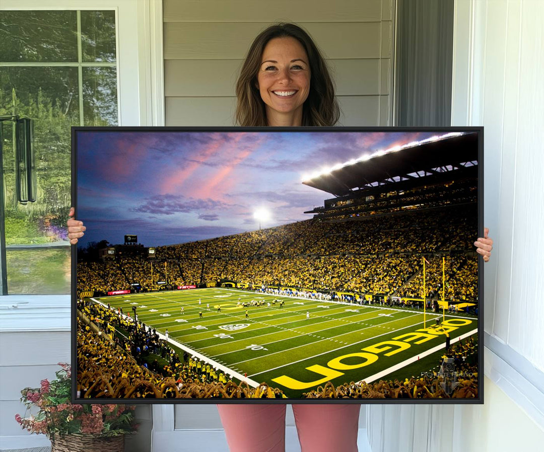 This gallery-quality canvas print features a depiction of the OREGON field filled with fans at sunset, capturing the essence of the University of Oregon Ducks Autzen Stadium.