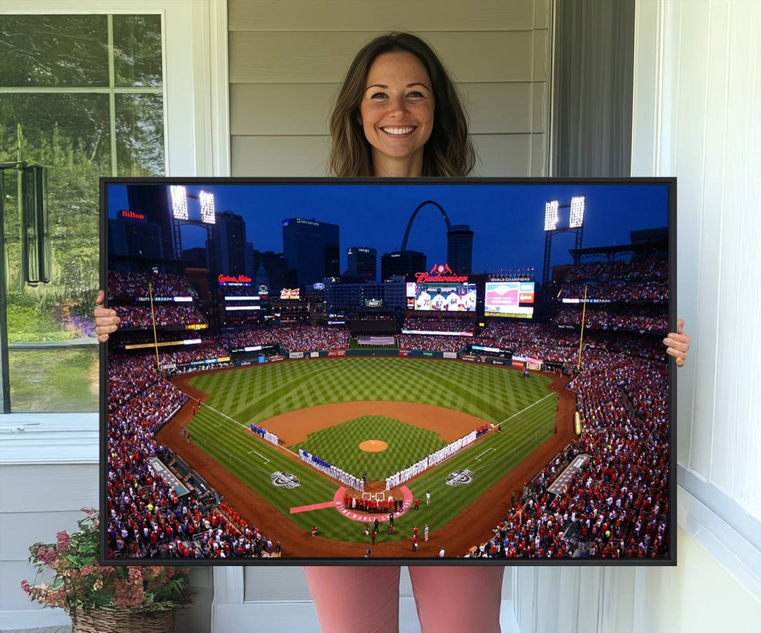 A Cardinals wall art canvas print depicts Busch Stadium with players lined up on the field and a full audience under the lights, capturing the vibrant atmosphere.