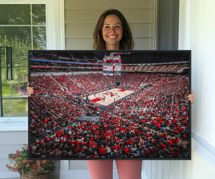 A painting of Louisville Cardinals fans in red at the KFC Yum Center Arena.