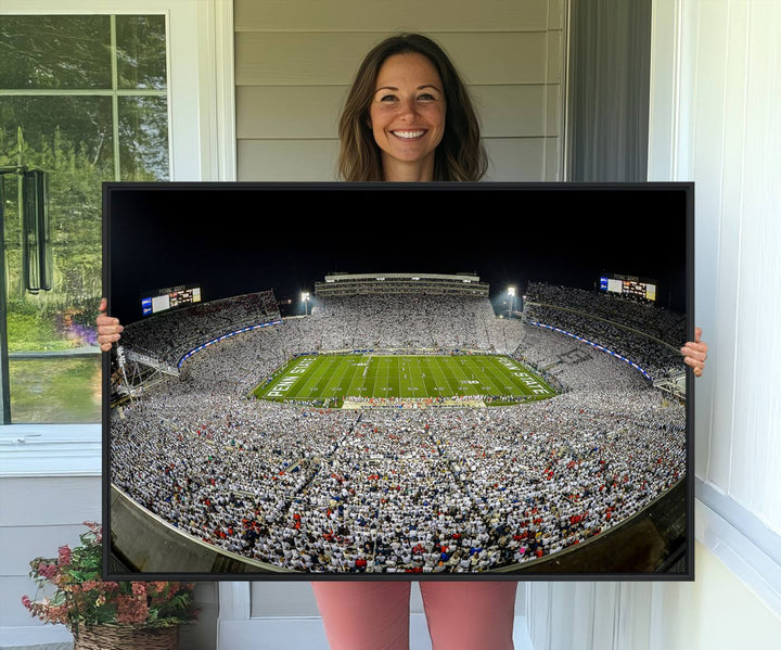 The triple canvas wall art depicts Beaver Stadiums vibrant atmosphere during a night game from the end zone.