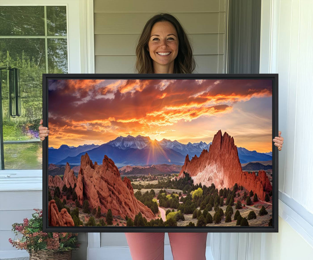 A vibrant sunset over the Rocky Mountains with red rocks.