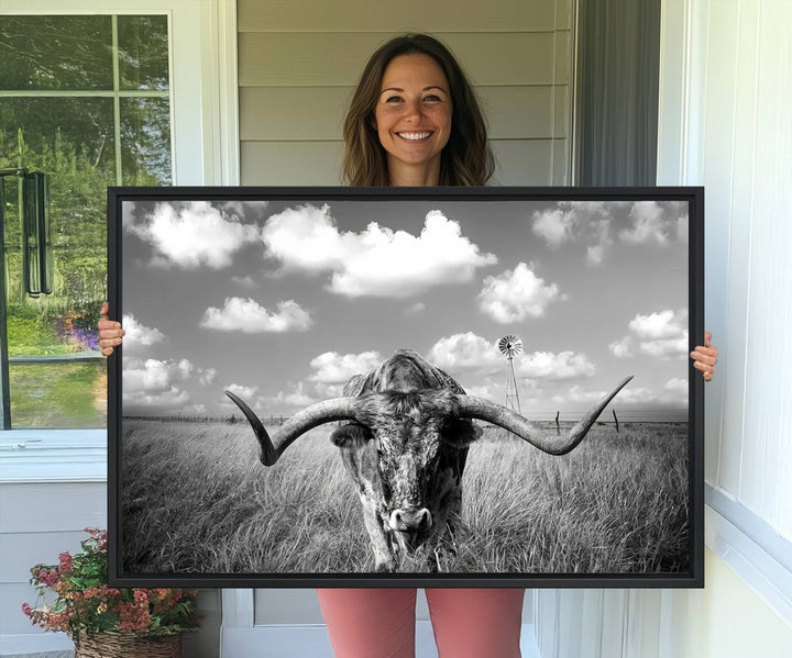 Longhorn Cow Field Canvas Print featuring rustic charm with a windmill backdrop.