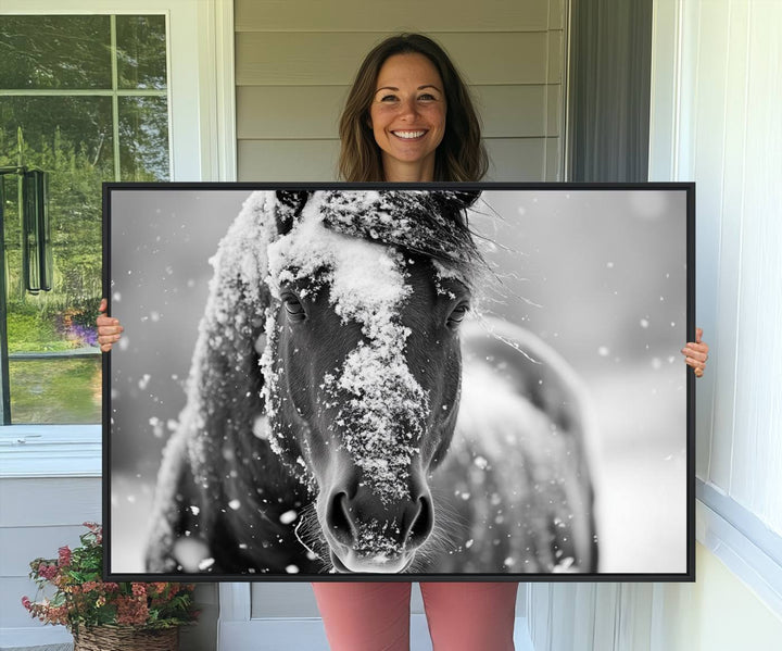 The Black and White Horse Winter Wall Art features a majestic horse with snow-covered hair set against a serene winter backdrop.