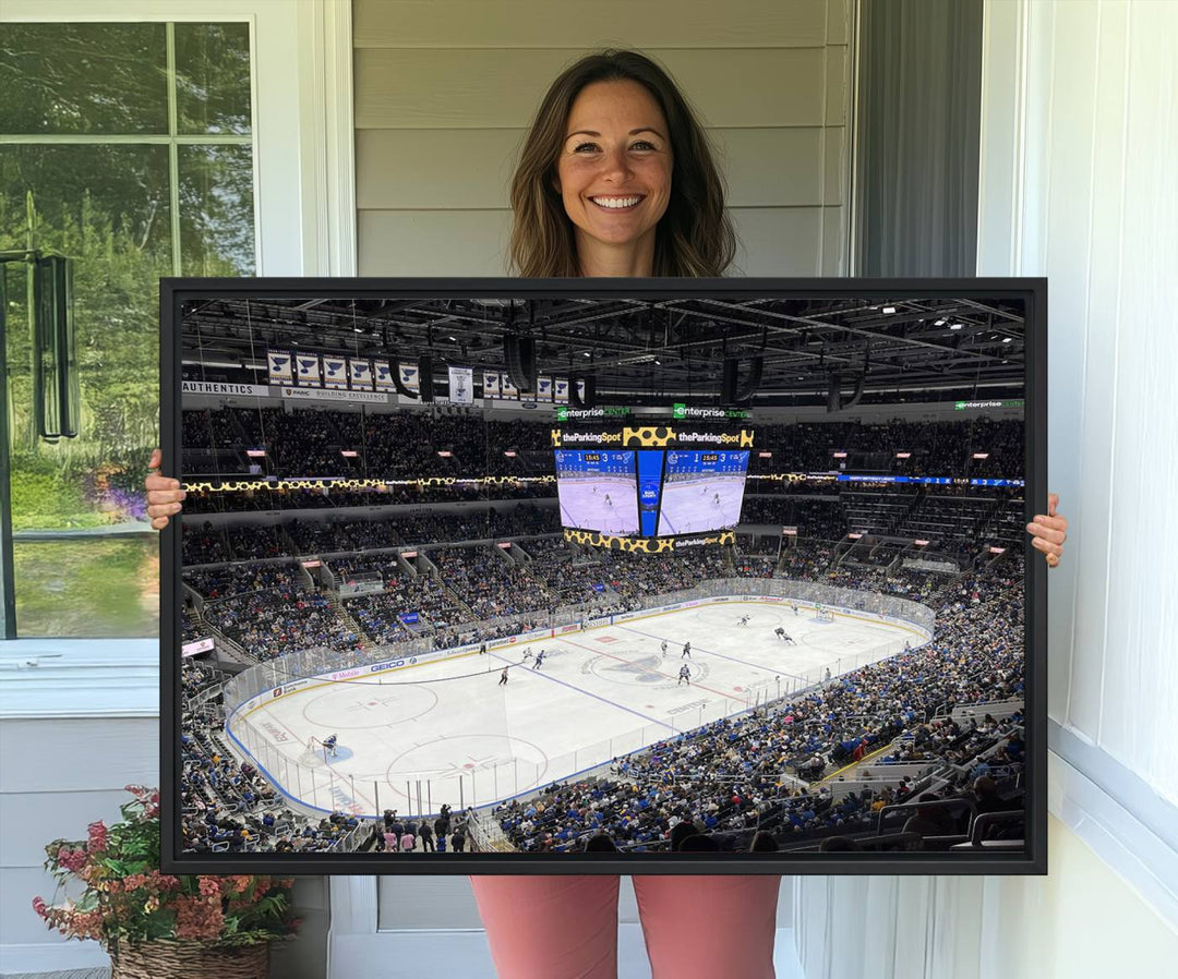 A large Enterprise Center canvas of a crowded hockey arena hangs prominently.