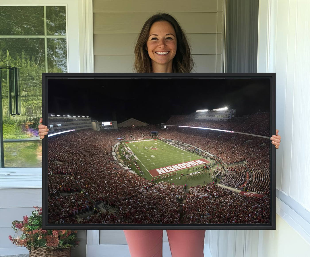 A painting of a stadium packed for a Wisconsin Badgers game, with WISCONSIN clearly visible in the end zone at Camp Randall Stadium.