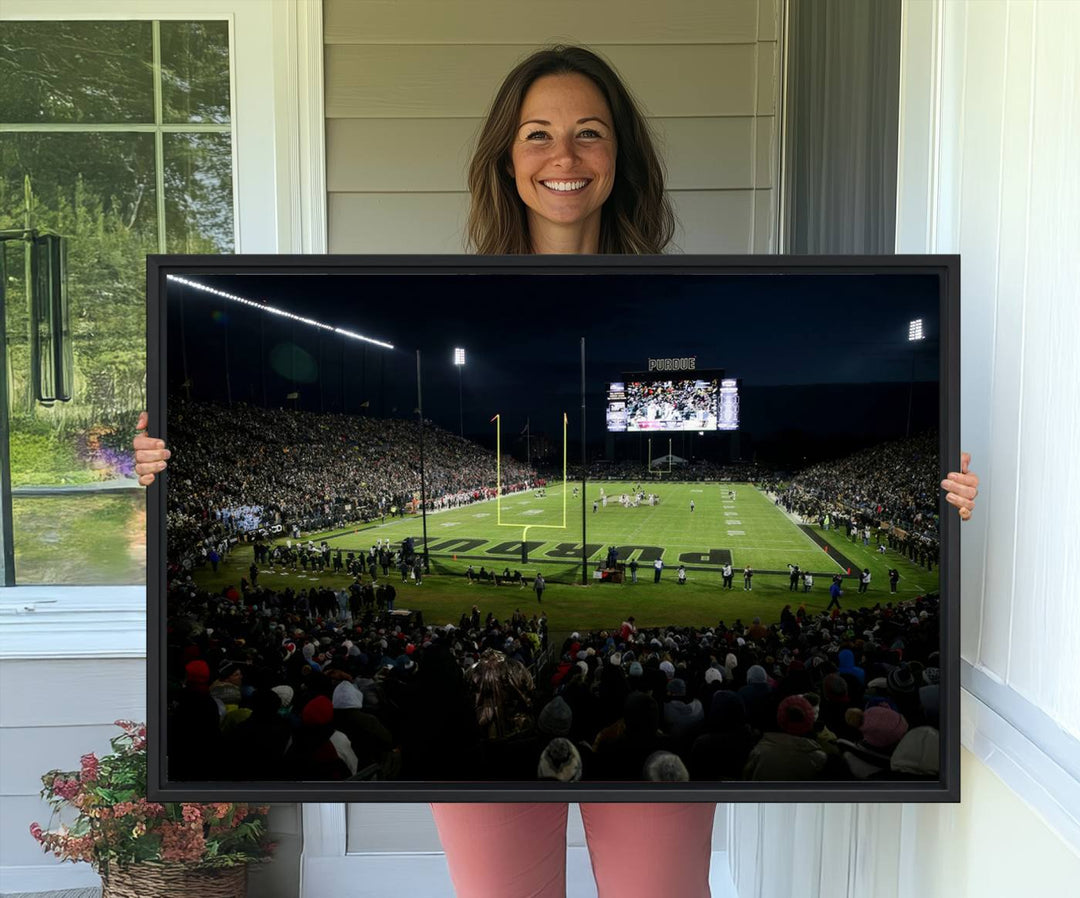 A Purdue Boilermakers canvas print beautifully showcases Ross–Ade Stadium in West Lafayette, vibrant with fans and a large screen display.