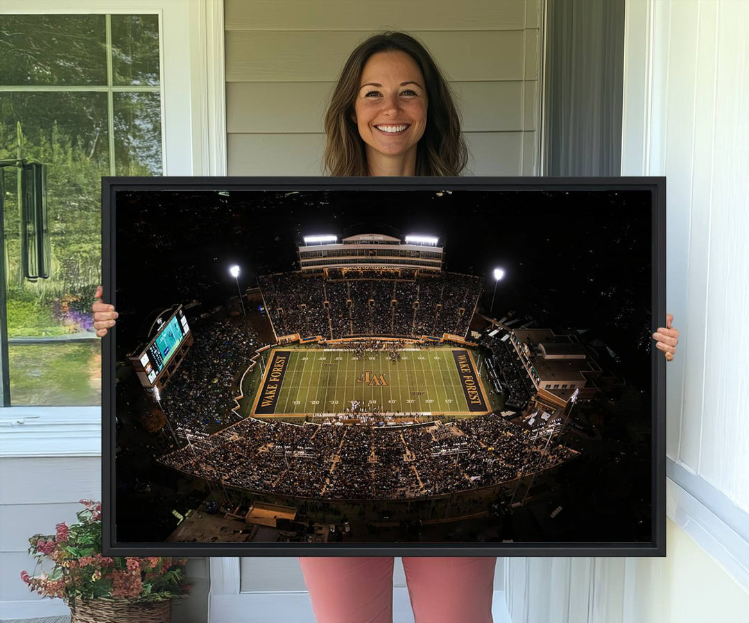 Canvas wall art displays an aerial view of Wake Forest Demon Deacons stadium at night.