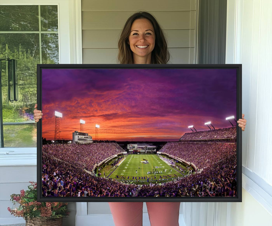 A sunset over Dowdy-Ficklen Stadium, Greenville, captured on museum quality canvas with vibrant purple and orange skies.