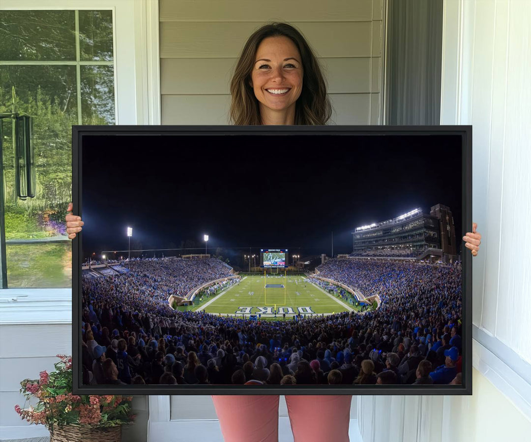 Under bright lights at night, the Duke Blue Devils Football Team Durham canvas wall art print is prominently displayed.